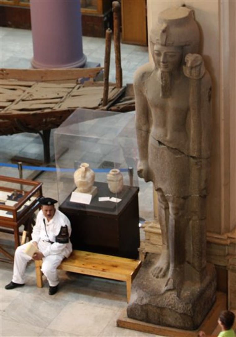 A police officer stands guard by a Pharaonic statue at the Egyptian Museum in Cairo, Egypt Tuesday, Aug. 24, 2010. Security for Egypt's cultural treasures is under scrutiny after the Aug. 21, 2010 theft of a van Gogh painting from Cairo's Mahmoud Khalil Museum museum revealed some alarming gaps.